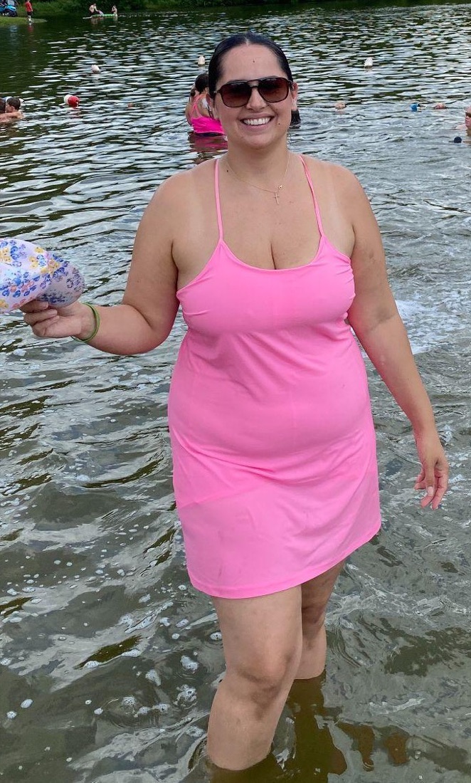 Dr. Amanda Perez at the lake in a pink dress